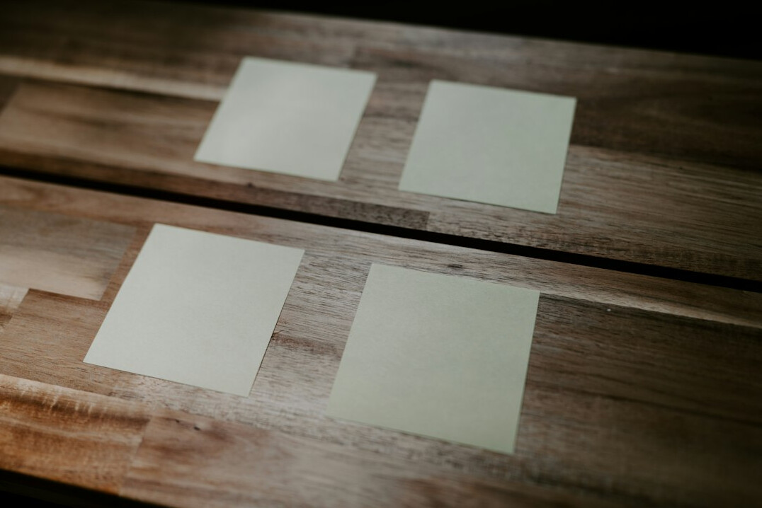 Team planning a software project on a glass whiteboard with sticky notes
